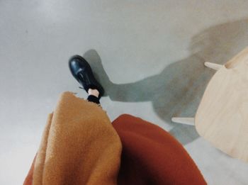 Close-up of human feet on tiled floor