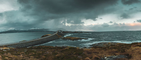 Scenic view of sea against storm clouds