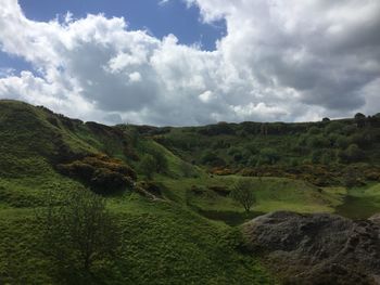 Scenic view of green landscape against sky