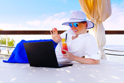 Smiling businesswoman gesturing on video call 