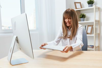 Young woman using laptop at home