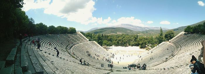 Panoramic view of people on mountain against sky