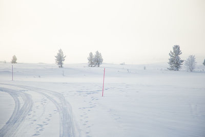 Snow covered field against sky