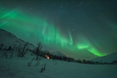 Scenic view of snowy landscape against sky at night