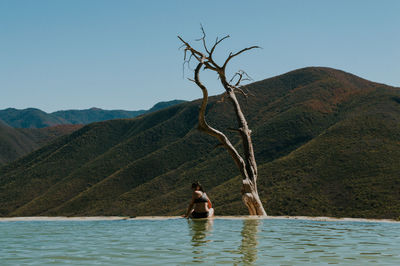 Man on mountain against sky