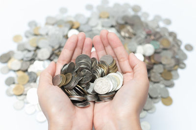 Close-up of hand holding coins