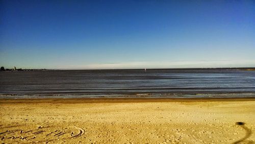 Scenic view of sea against clear blue sky