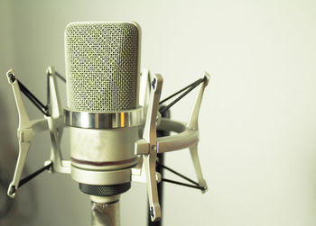 Close-up of microphone against wall