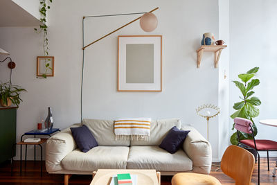 Couch and swinging lamp in loft apartment living room