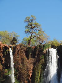 Scenic view of waterfall against clear sky