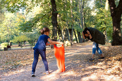 Side view of two women standing on land