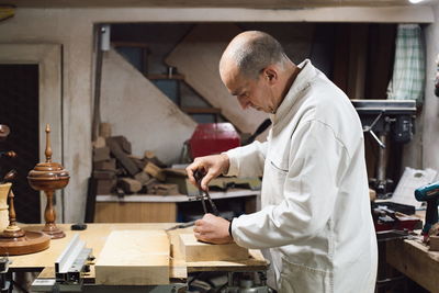 Side view of man working in workshop