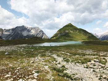 Scenic view of lake and mountains against sky