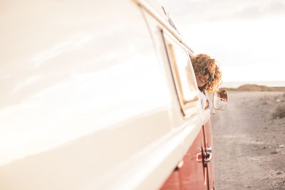 Smiling woman in van on road