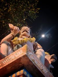 Low angle view of woman at night