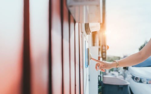 Cropped image of person on window against sky