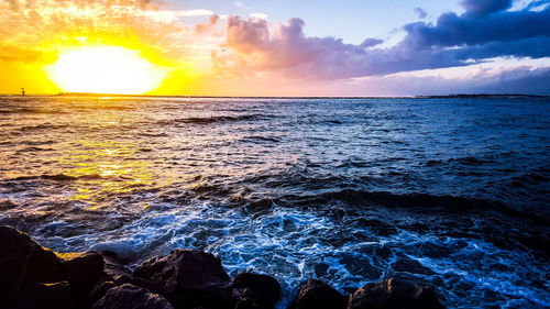 Close-up of sea against sky during sunset