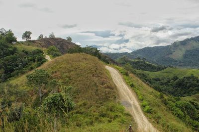 Panoramic view of road amidst landscape against sky