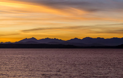 A silhouette shot of a sunset over the olympic mountains in washington state.