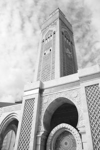 Low angle view of building against cloudy sky