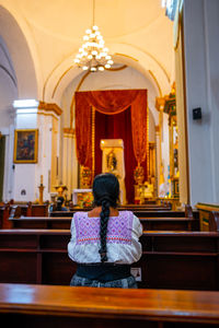 Rear view of woman standing in church