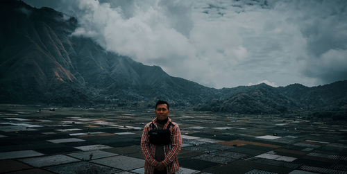 Man standing on mountain against sky