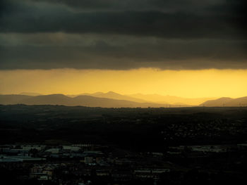 Aerial view of cityscape against sky during sunset