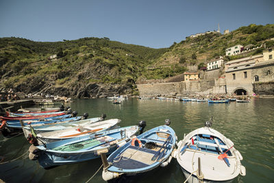 Boats on river with buildings in background