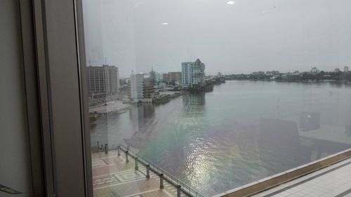 City by river against sky