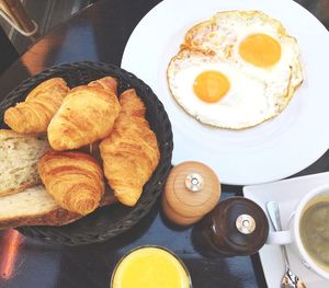 High angle view of egg and croissants on table