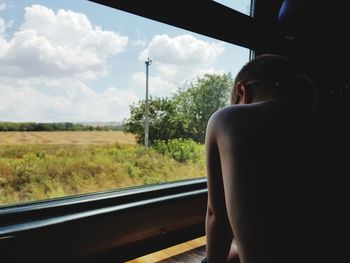 Man looking through train window