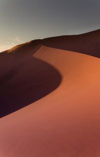 Scenic view of desert against sky during sunset