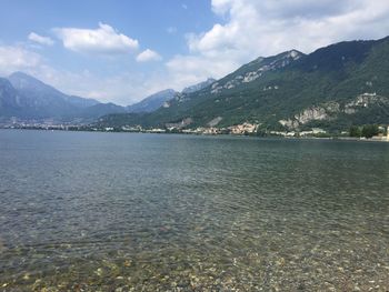 Scenic view of sea and mountains against sky