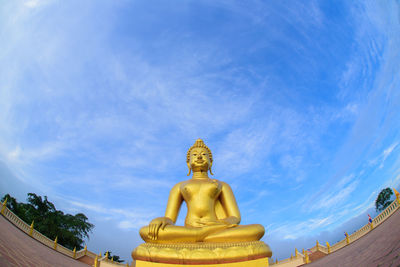 Low angle view of statue against temple against sky