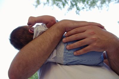 Midsection of couple holding hands