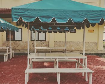 Empty chairs and tables at beach
