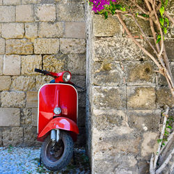 Red fire hydrant against wall