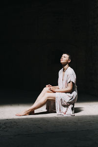 Young man sitting in sunlight