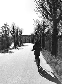 Rear view of man walking on road