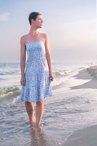 Young woman standing at beach