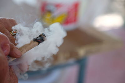 Close-up of hand holding cigarette