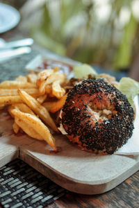 Close-up of burger and french fries on cutting board