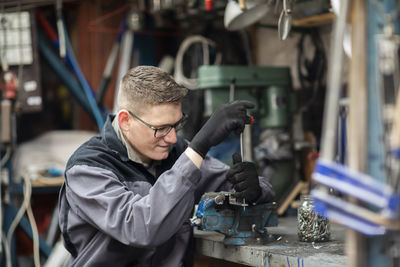 Plumber male working in a workshop