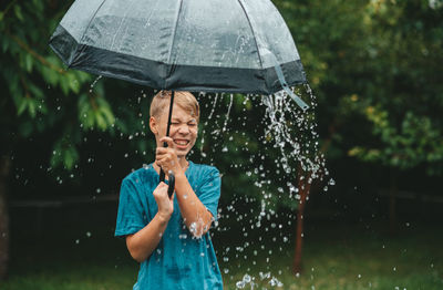 Boy holding umbrella