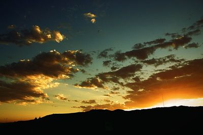 Low angle view of silhouette trees against sky at sunset