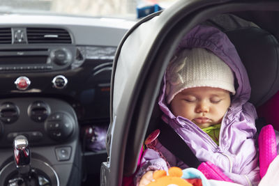 Portrait of cute girl in car