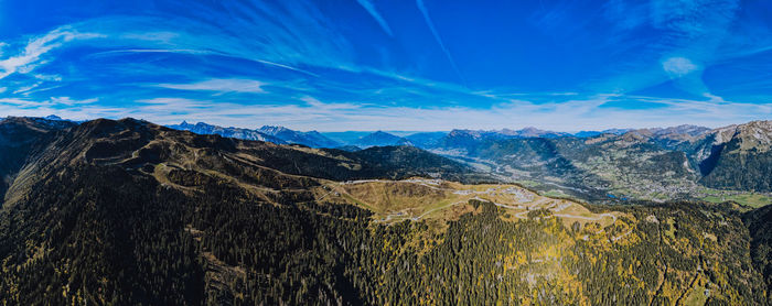 Scenic view of mountains against blue sky