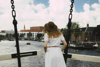 Woman on bridge overlooking city