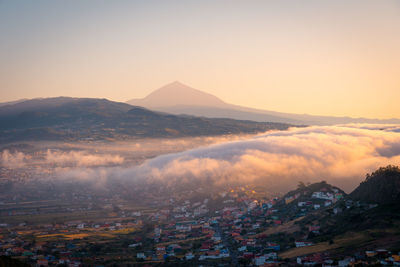 High angle view of townscape and mountains against sky