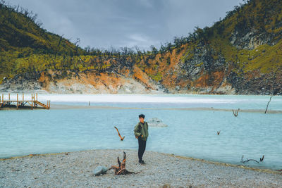 Rear view of woman walking at beach